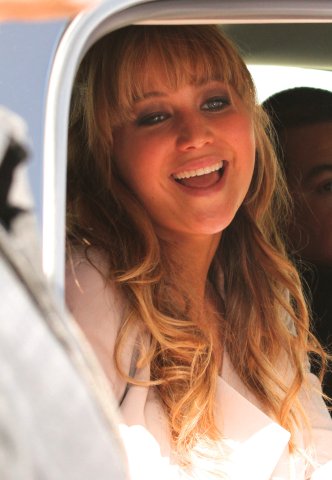 Jennifer Lawrence in her car greeting fans on her way to The Hunger Games The Hob Event.
